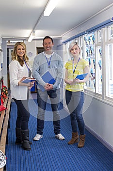 Three Teachers in School Corridor