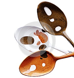 Three teaspoons are painted in different colors with acrylic paint