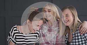 Three teen girl friends laughing