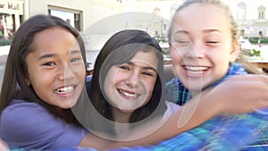 Three Teenage Girls Posing For Camera In Shopping Mall