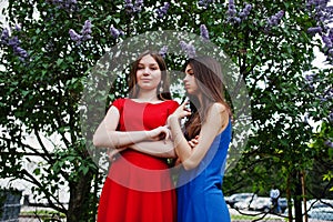 Three teenagers girl in blue and red dresses