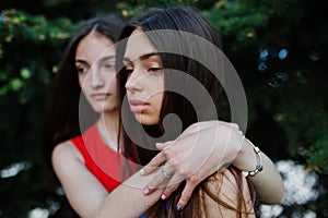 Three teenagers girl in blue and red dresses