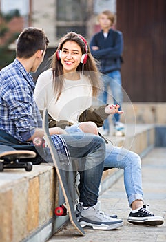 Three teenagers hanging out outdoors