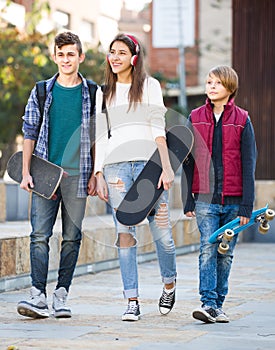 Three teenagers with skateboards outdoor