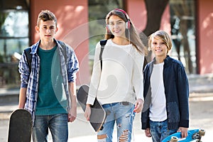 Three teenagers with skateboards outdoor