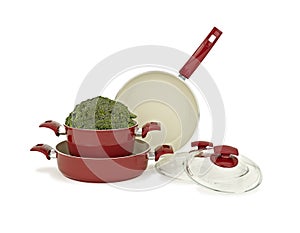 Three teflon, stainless steel pan set and vegetable