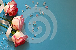 Three tender roses on a blue background