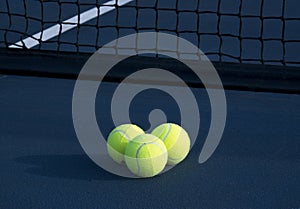 Three Tennis Balls on a Tennis Court