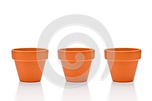 Three terracotta flower pots isolated on white