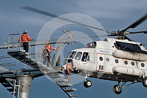 Three thumping assemblers under the helicopter