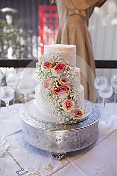 Three tiered wedding cake with roses
