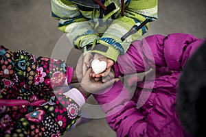 Three toddler girls holding their hands joined together with the photo