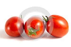 Three tomatoes isolated on white background.