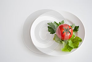 Three tomatoes with salad on a plate