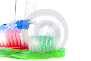 Three toothbrushes with water tumbler