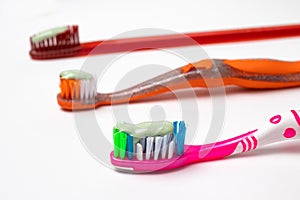 Three toothbrushes for the whole family. Care for the mouth, brushing teeth. Toothpaste and toothbrush