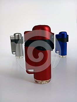 Three torch lighters a white background