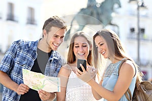 Three tourist friends consulting gps on smart phone