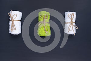 three towels for spa procedures on a dark table place for an inscription