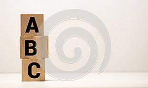 Three toy wooden blocks with letters ABC on them