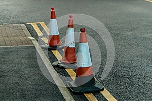 three traffic cones on double yellow lines