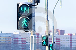 Three traffic lights for pedestrians show the time left to cross the road
