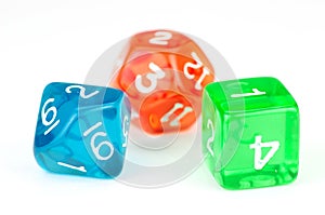 Three translucent, colored dice on white