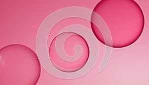 Three translucent pink spheres floating against a soft pink gradient background