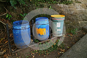 Three trash cans by the roadside