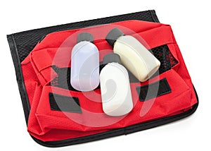 Three travel size bottles on a toiletries bag