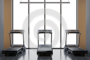 Three treadmills in a brown room