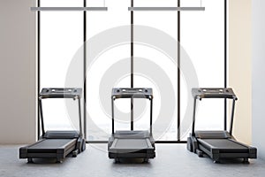 Three treadmills in a white room