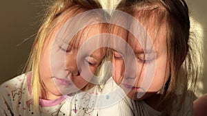 Three triplet sisters expose their faces to the sunlight