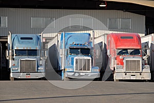Three trucks at warehouse