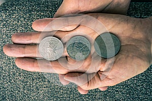 Three Tunisian coins on the woman's palm