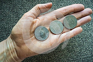 Three Tunisian coins on the woman's palm