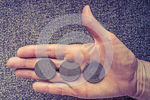 Three Tunisian coins on the woman's palm