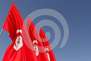 Three Tunisian flags on flagpole on blue background. Place for text. The flag is unfurling in wind. North Africa. 3D illustration