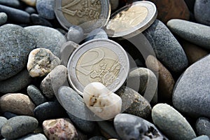 Three two euro coins. 2 euro coins in pebbles.