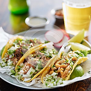 Three types of mexican street tacos with barbacoa, carnitas and ChicharrÃÂ³n photo