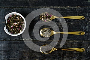 Three types of tea in spoons - green, black and Rooibos