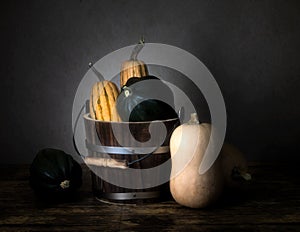 Three types of winter squash and a bucket