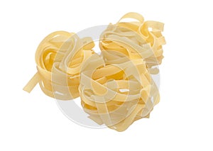 Three uncooked nests of tagliatelle pasta