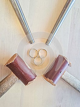 Three unfinished rings and jeweler's tools lie on the table