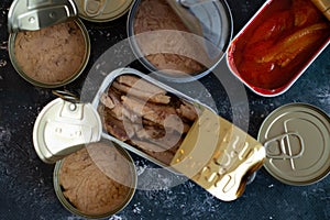 Three varieties of sardine cans, with tomato and with olive and sunflower oil