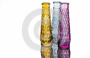 Three vases of colored glass with a pattern