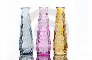 Three vases of colored glass with a pattern