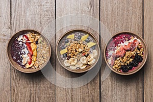 Three vegan and healthy fruits desserts on a wooden table