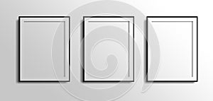 Three vertical fotos frames, 3d white blank on grey white wall with black borders. 3 fotos photo