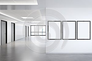 Three vertical frames Mockup hanging on wall. Mock up of billboards in modern concrete office interior 3D rendering